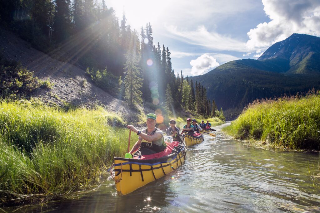 Group kayaks in Nahanni River in Canada