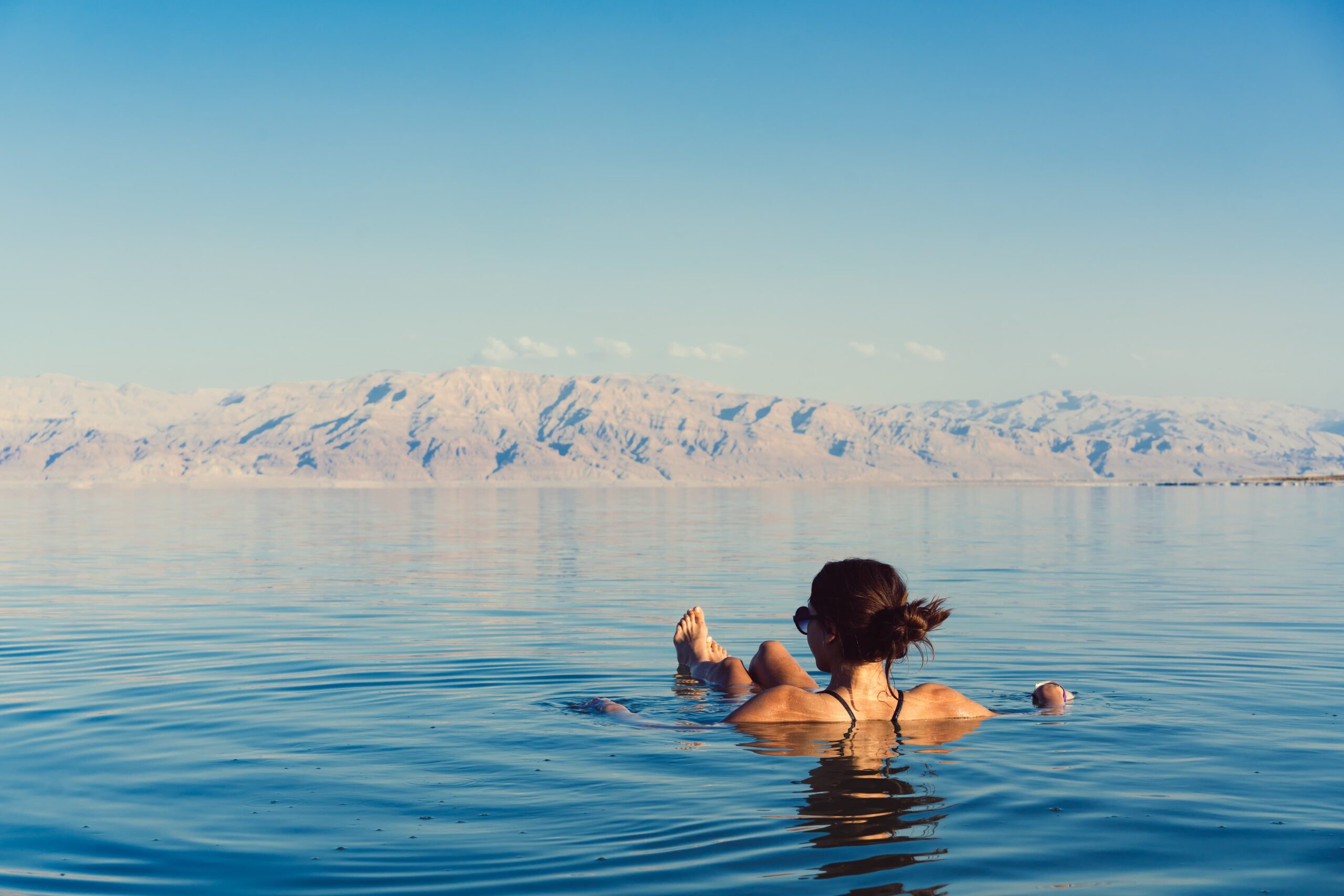 Woman floating in the Dead Sea, Israel