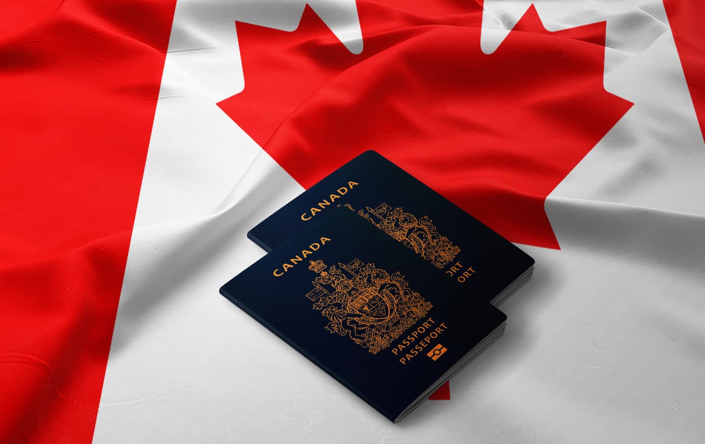 2 Canadian passports on a Canadian flag