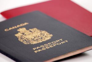 Canadian passport laying on a red background